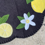 Close up a a lemon flower blossom on a felt ITH candle mat by snugglepuppyapplique.com