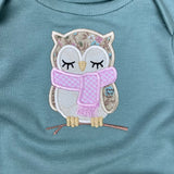 An applique of a sleepy owl wearing a scarf by snugglepuppyapplique.com