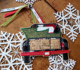 Christmas tree in the back of a pickup truck bed applique machine embroidery design by snugglepuppyapplique.com