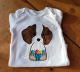 An applique of a puppy holding an easter basket in it's mouth by snugglepuppyapplique.com