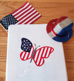 An applique of a butterfly  made like an American Flag, 4th of July, by snugglepuppyapplique.com