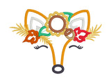 An applique of a fox face wearing a crown of Autumn foliage, sunflower, acorn and leaves by snugglepuppyapplique.com