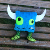 In the hoop Monster stuffy with one tooth, two horns and two legs by snugglepuppyapplique.com