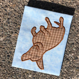 an applique of a dog sleeping on her back with legs in the air by snugglepuppyapplique.com