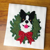 An applique of a Boston Terrier with his head through a Christmas Wreath by Snugglepuppyapplique.com
