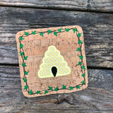 An in the hoop summer coaster of a bee hive with an ivy boarder by snugglepuppyapplique.com