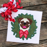 An applique of a Pug with its head through a Christmas Wreath by snugglepuppyappliuque.com
