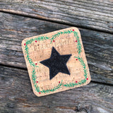 An in the hoop coaster embroidery design with a star in the center and evergreen sprigs and berries boarder by snugglepuppyapplique.com