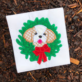 An applique of a Shih Tzu dog with its head through a Christmas Wreath by snugglepuppyapplique.com