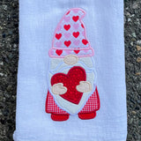 An applique of a gnome holding a heart by snugglepuppyapplique.com