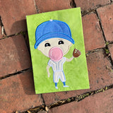 An applique of a baseball player holding a mitt an blowing a bubble by snugglepuppyapplique.com