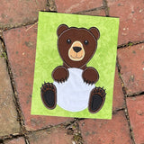 An applique of a bear holding a Volleyball by snugglepuppyapplique.com