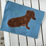 An applique of a dachshund giving puppy dog eyes by snugglepuppyapplique.com