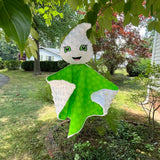 An in the hoop embroidery design of a ghost's head attached to a small blanket by snugglepuppyapplique.com