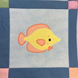 An applique of a cute tropical fish by snugglepuppyapplique.com