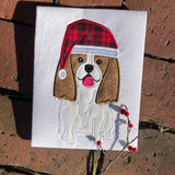 An applique of a Cavalier King Charles Spaniel wearing a Santa hat  by snugglepuppyapplique.com