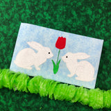 Opposing Bunnies with tulip between them bean stitch applique embroidery design by snugglepuppyapplique.com