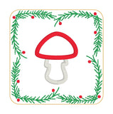 In the hoop Winter coaster with mushroom in the center and a border of evergreen boughs and berries by snugglepuppyapplique.com  Edit alt text