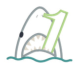 An applique of a shark biting the number one by snugglepuppyapplique.com