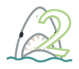 An applique of a shark biting the number two by snugglepuppyapplique.com