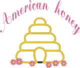 An applique of a beehive with flowers and the words "American honey" embroidered above by snugglepuppyapplique.com