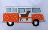 An applique of a bus with a side door that slides open on grosgrain ribbon to reveal an embroidered Labrador by snugglepuppyapplique.com