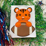 Tiger Mascot with a football applique embroidery design, snugglepuppyapplique.com