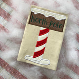 North Pole sign applique machine embroidery design by snugglepuppyapplique.com