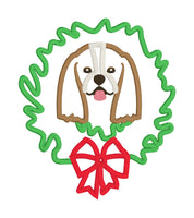 An applique of a Cavalier King Charles Spaniel with its head through a Christmas wreath in 6 sizes by snugglepuppyapplique.com