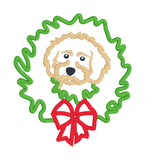 An applique of a Cockapoo dog with its head though a Christmas wreath in 6 sizes by snugglepuppyapplique.com