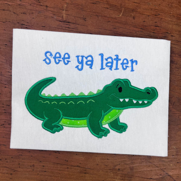 An applique of an Alligator with words "see you later" by snugglepuppyapplique.com
