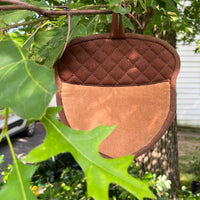 An acorn shaped potholder handing in a tree by snugglepuppyapplique.com