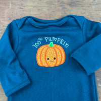 An embroidery design of a cute applique pumpkin with the words "100% Pumpkin" embroidered above it.