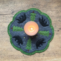 An in the hoop candle mat punny rug with bears, evergreen trees and stars embroidery design by snugglepuppqapplique.com