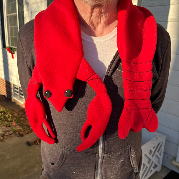 An in the hoop fleece scarf shaped like a lobster by snugglepuppyapplique.com