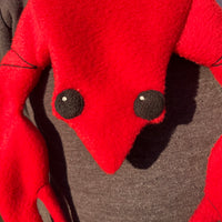 Close up of an In the hoop scarf shaped like a lobster.