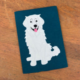 An applique design of a Great Pyrenees sitting and panting by snugglepuppyapplique.com