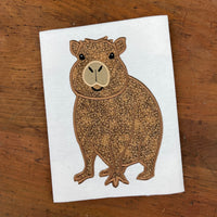 An applique of a cute capybara by snugglepuppyapplique.com i