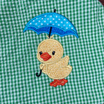 An applique of a duckling holding an umbrella by snugglepuppyapplique.com