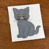 an applique of a sitting kitten by snugglepuppyapplique.com