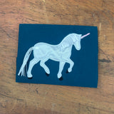 An applique of a unicorn with ribbon mane and tail by snugglepuppyapplique.com