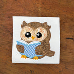 An applique of an owl reading a book by snugglepuppyapplique.com