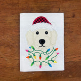 An applique design of a golden doodle dog wearing a Santa hat and wrapped in Christmas lights in 6 sizes by snugglepuppyapplique.com