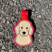 An in the hoop Key Fob of a Golden Doodle dog by snugglepuppyapplique.com