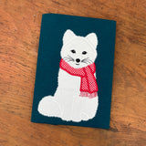 An applique of an arctic Fox wearing a scarf by snugglepuppyapplique.com