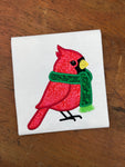 An applique of a cardinal wearing a scarf by snugglepuppyapplique.com