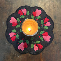 An in the hoop valentine candle mat with heart flowers and leaves made from wool felt by snugglepuppyapplique.com