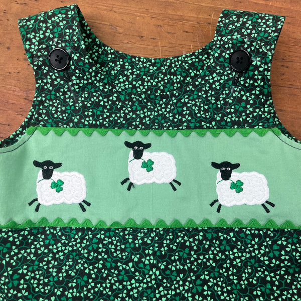 An applique of three whimsical sheep leaping with clover in their mouths by snugglepuppyapplique.com