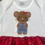 An applique of a little mouse wearing overalls and chewing on a stock of wheat by Snugglepuppyapplique.com
