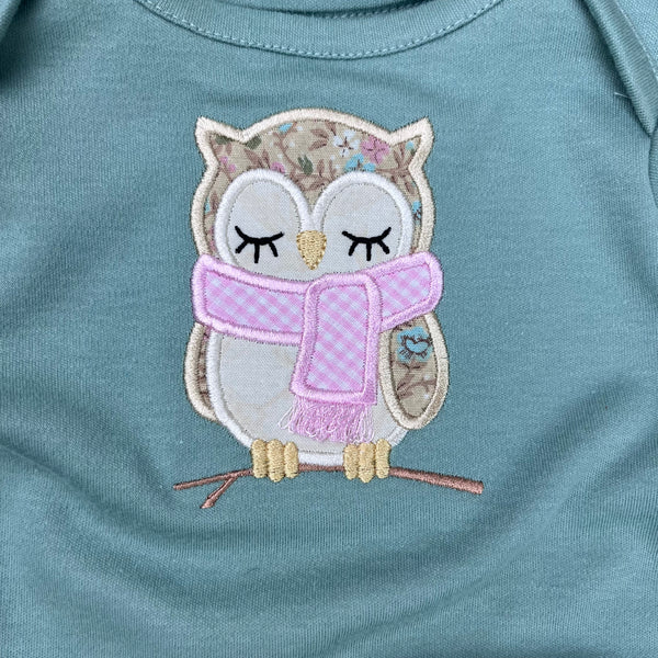 An applique of a sleepy owl wearing a scarf by snugglepuppyapplique.com